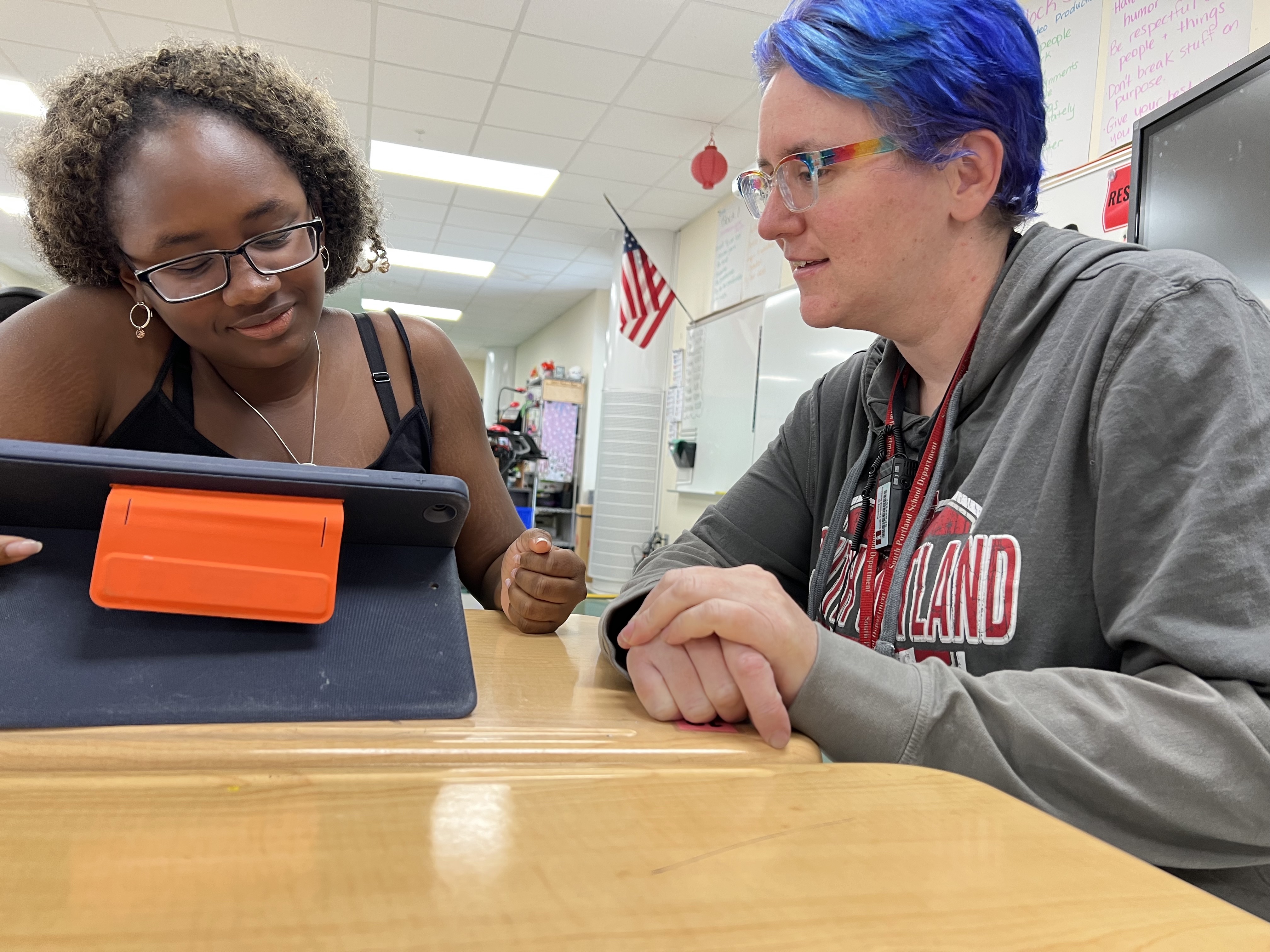 Julie working with a student on a tablet